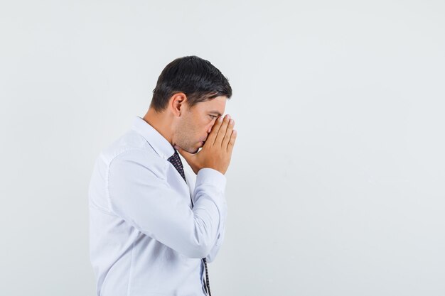 An expressive man is posing in the studio