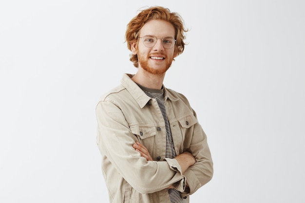 Expressive redhead guy in beige shirt