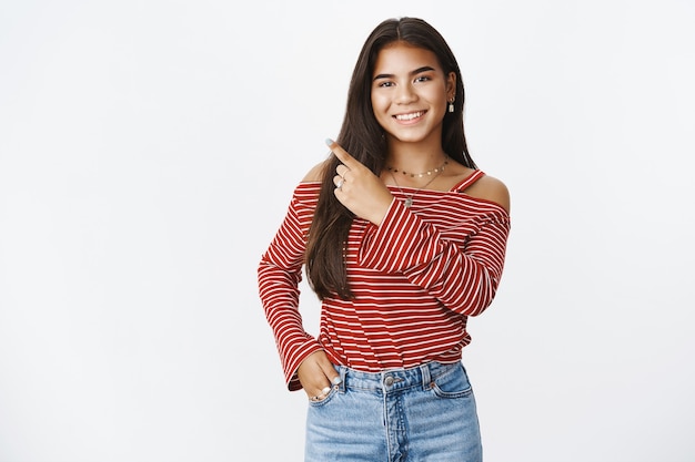 An expressive teenage girl in a striped blouse