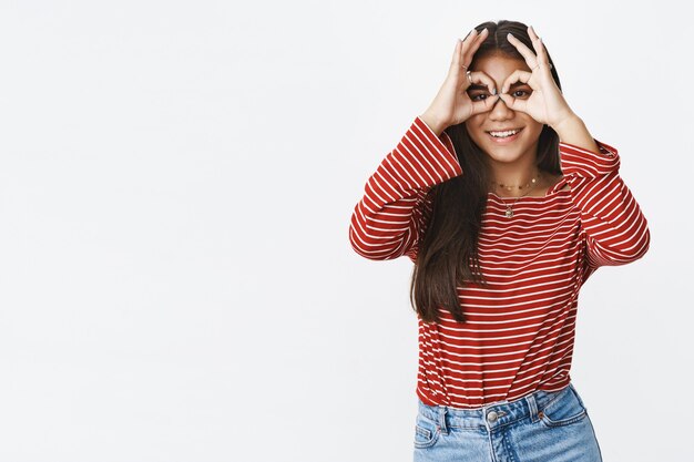 An expressive teenage girl in a striped blouse