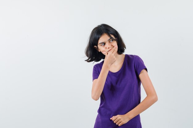 An expressive teenager is posing in the studio