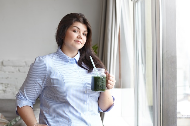 An expressive woman is posing in the house