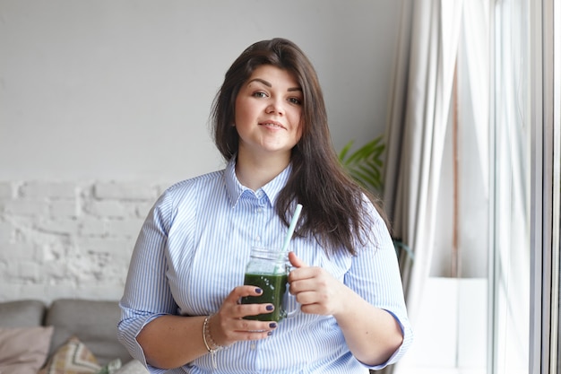 An expressive woman is posing in the house