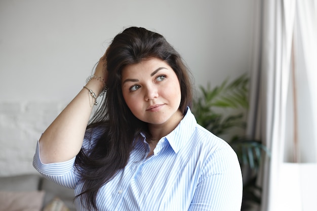 An expressive woman is posing in the house