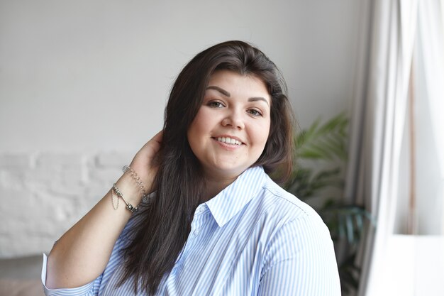 An expressive woman is posing in the house