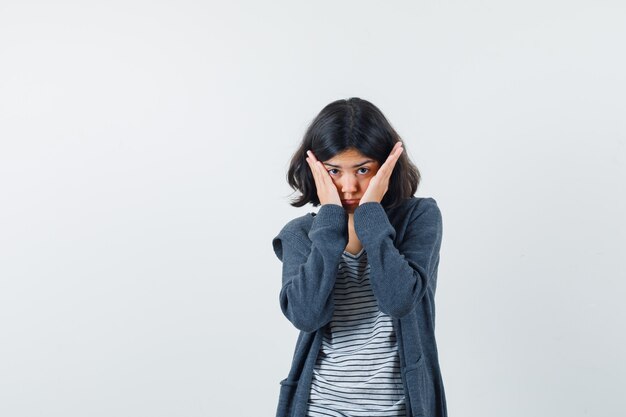 An expressive woman is posing in the studio