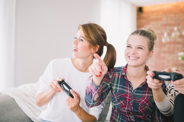 Expressive women playing game at home