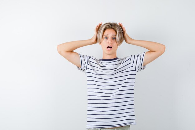 Expressive young boy posing in the studio