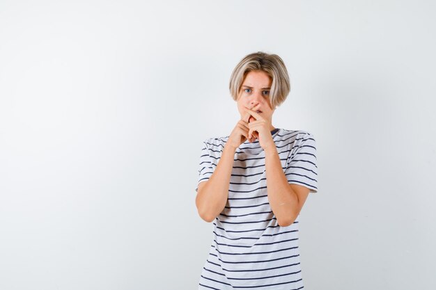 Expressive young boy posing in the studio