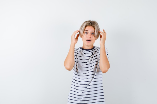 Expressive young boy posing in the studio