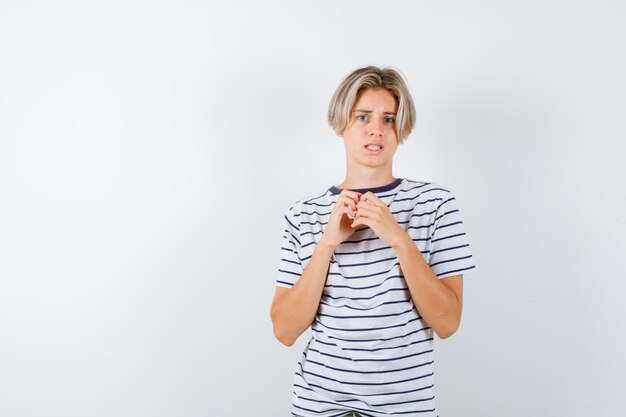 Expressive young boy posing in the studio