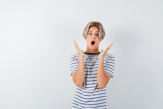 Expressive young boy posing in the studio