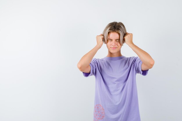 Expressive young boy posing in the studio