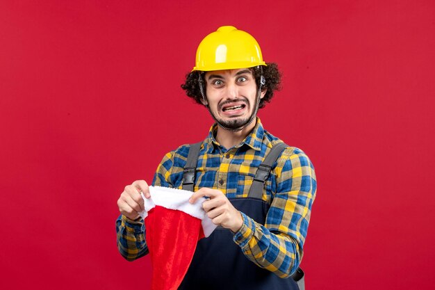 Expressive young builder posing for winter holidays