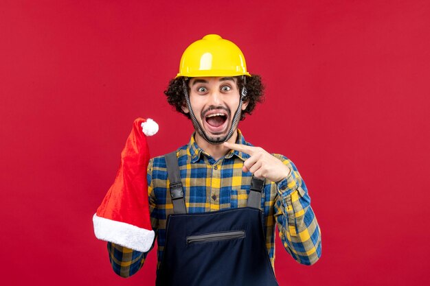 Expressive young builder posing for winter holidays