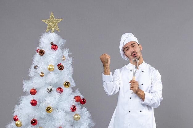 Expressive young cook posing for winter holidays