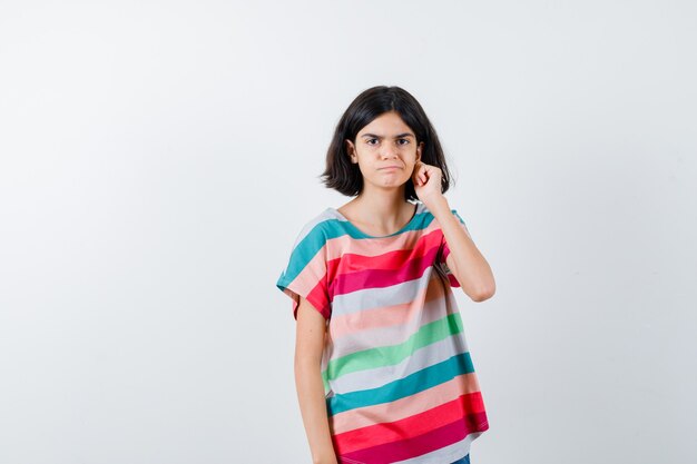 Expressive young girl posing in the studio