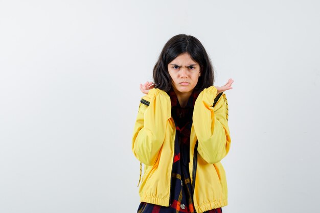 Expressive young girl posing in the studio