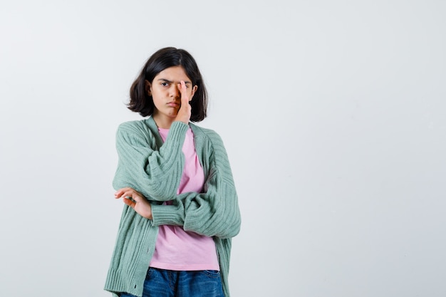 Expressive young girl posing in the studio