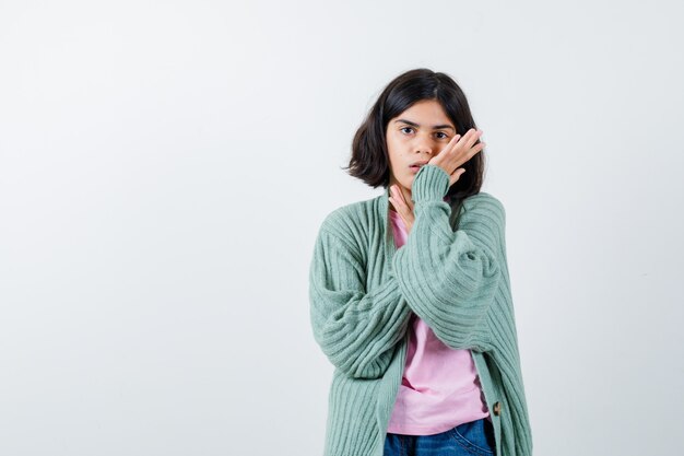 Expressive young girl posing in the studio