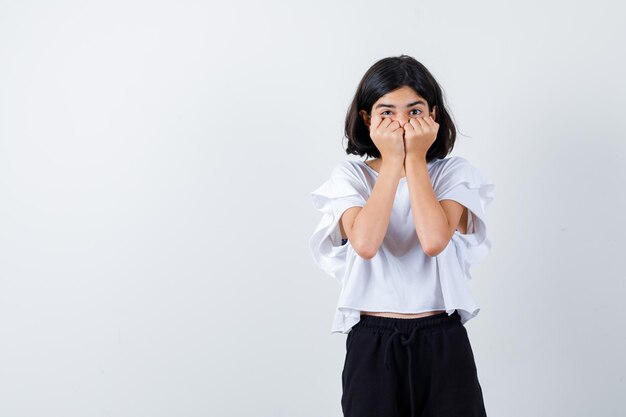 Expressive young girl posing in the studio