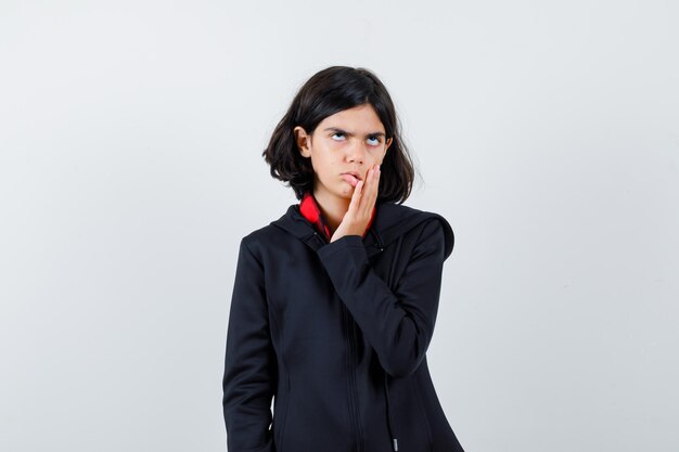 Expressive young girl posing in the studio