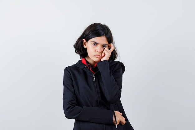 Expressive young girl posing in the studio