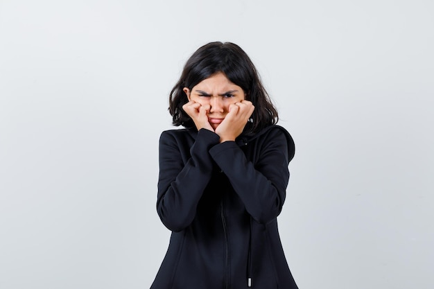 Expressive young girl posing in the studio