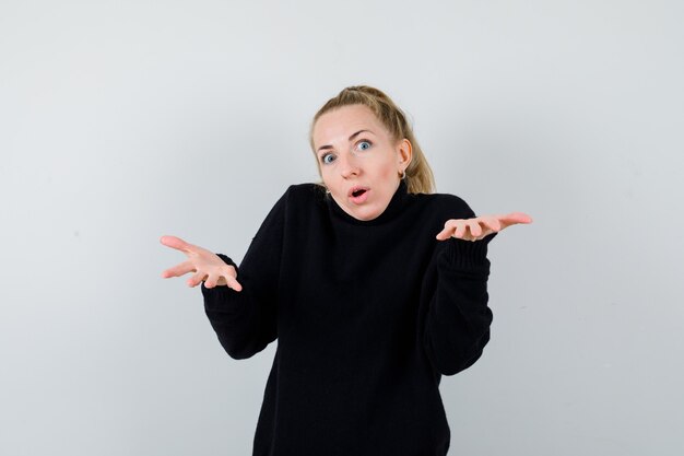 Expressive young woman posing in the studio