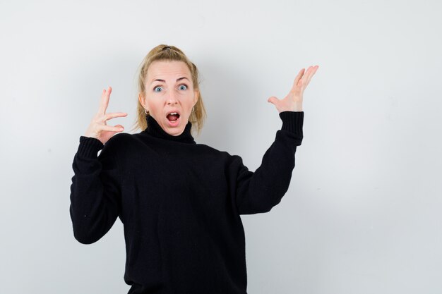 Expressive young woman posing in the studio