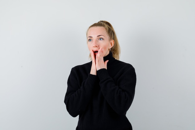 Expressive young woman posing in the studio