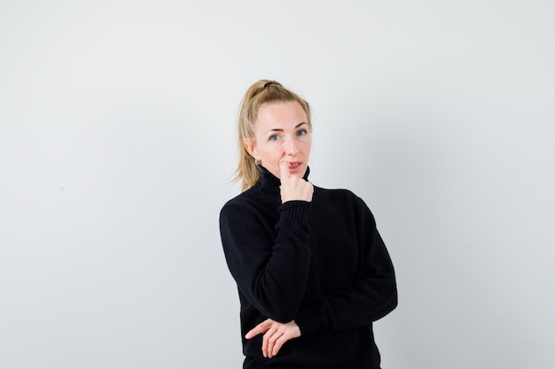 Expressive young woman posing in the studio