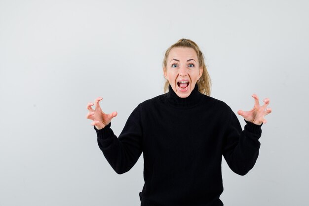 Expressive young woman posing in the studio