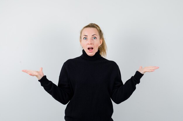 Expressive young woman posing in the studio