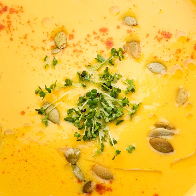 Free photo extreme close-up creme soup with seeds and herbs