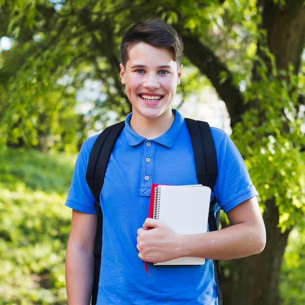 Free photo extremely happy teenager with notebooks