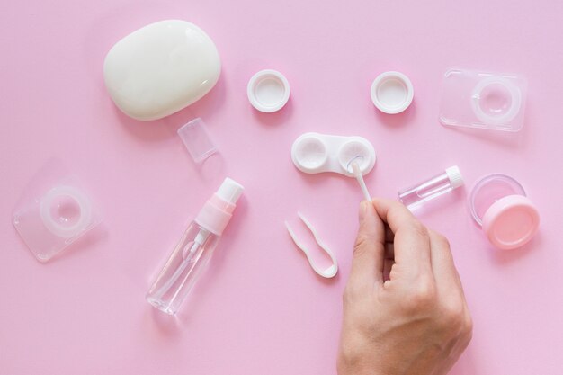 Eye care accessories on pink background