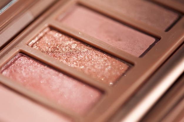 Eye shadows with glitter in pink shade closeup. selective focus.