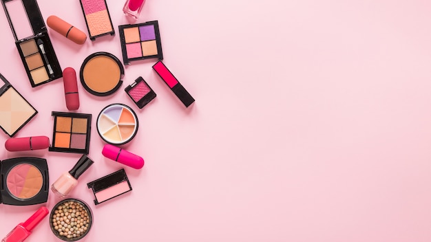 Eye shadows with lipsticks on pink table 