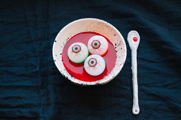 Free photo eyeballs in plate with fake blood