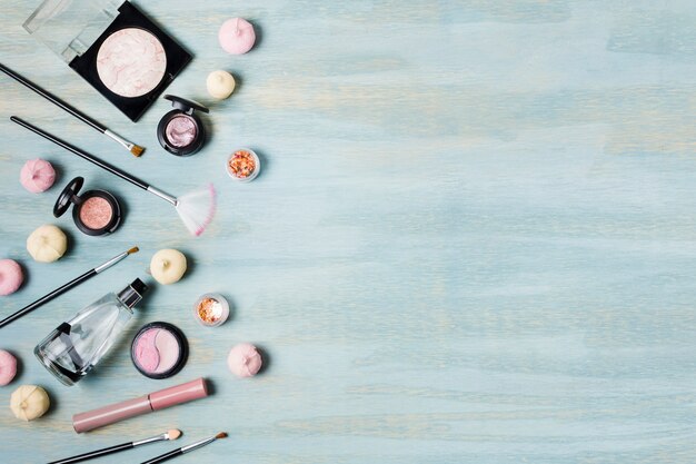 Eyeshadow brushes and cosmetics next to sweets