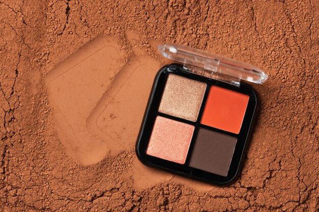 eyeshadow palette with multiple shades and cosmetic powder