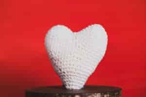 Free photo fabric heart on a red background