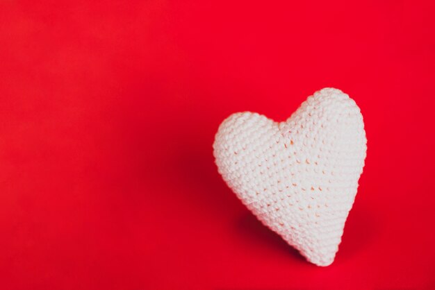 Fabric heart on a red background