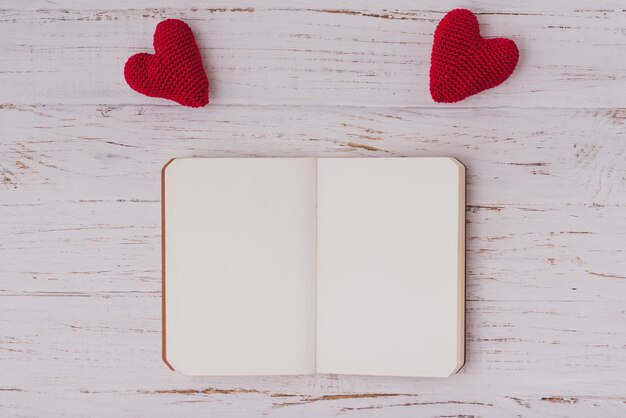 Fabric hearts on top of a blank notepad