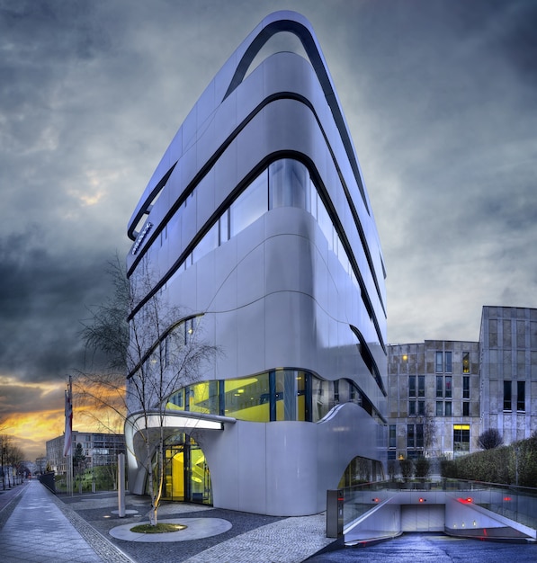 Facade of a modern building with geometric windows and curved walls