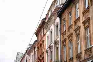 Free photo facades of old houses in a row against the sky