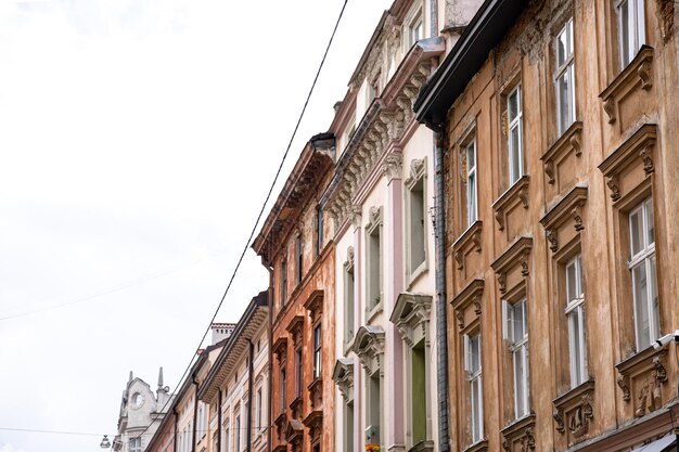 Facades of old houses in a row against the sky