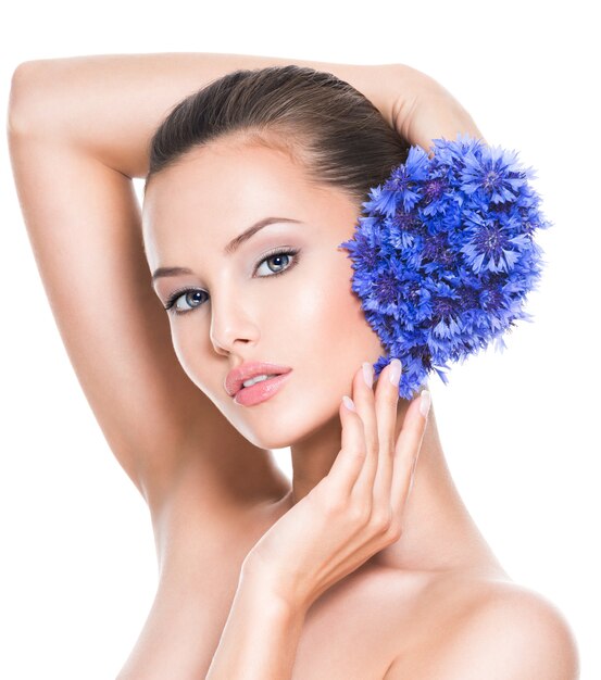 Face of a beautiful girl  with blue posy fild flowers