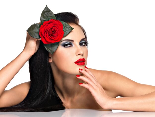 Face of  the  beautiful woman with  bright fashion makeup and red flower -  isolated